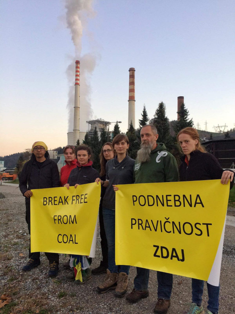 The crew stands before a coal plant in Velenje, Slovenia.